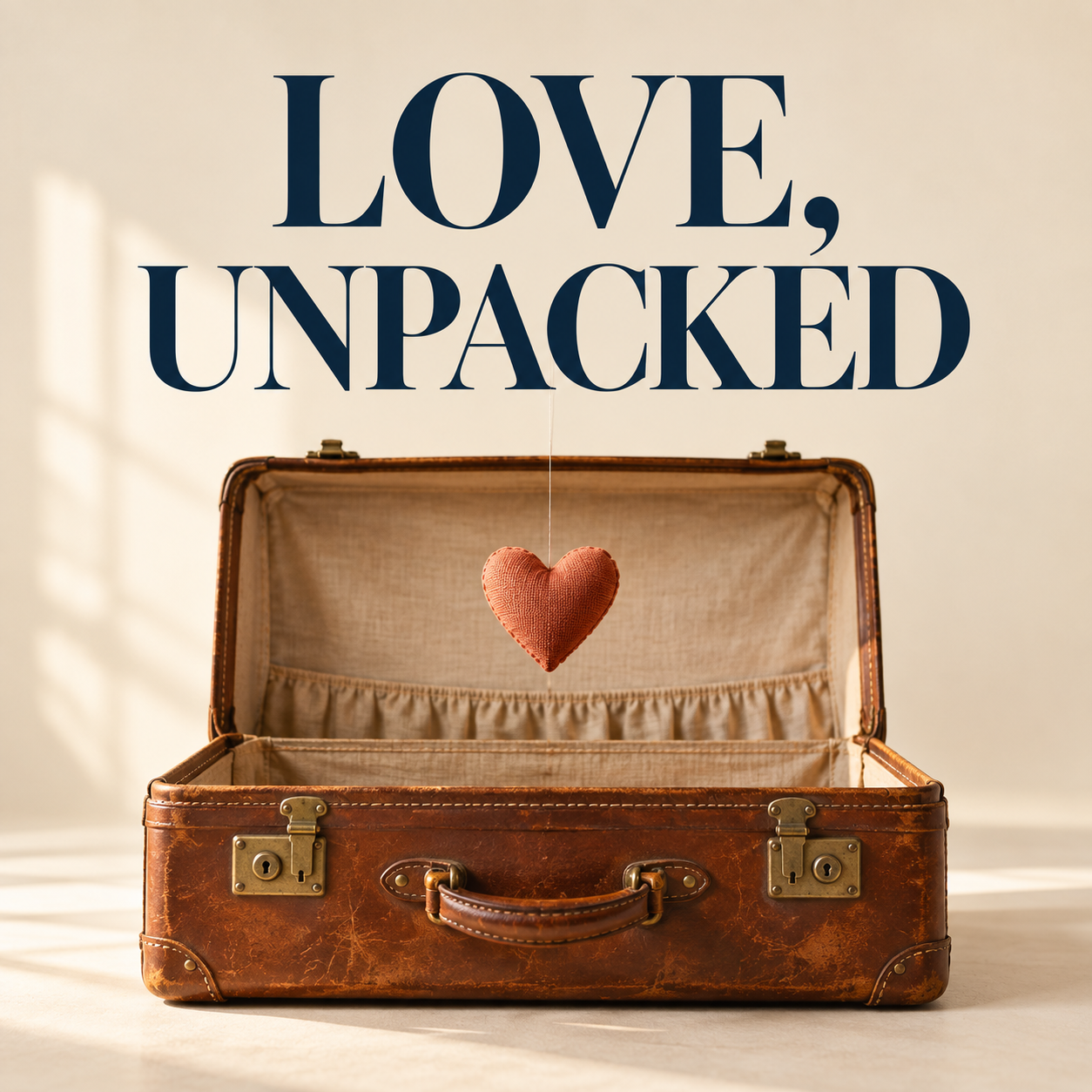 Love, Unpacked official artwork: an open vintage suitcase with a suspended heart
